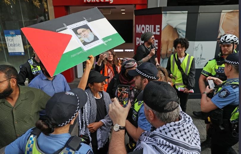 Palestine protest in Forrest Place. Pictured - A woman is spoken to by police about her sign.